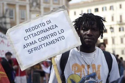  Protest for basic income A protester holds a placard expressing his opini... Stock Photos