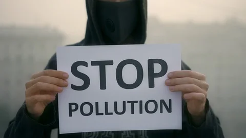 Protest in breath mask stand background city fog with message stop pollution 4K Video stock 114991159