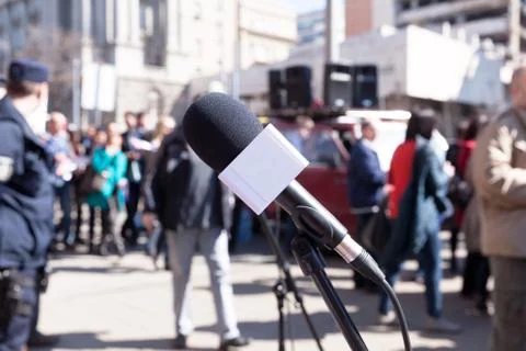 Protest. Demonstration. microphone in focus, blurred protesters in background Stock Photos