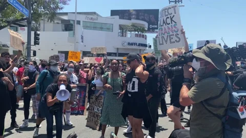 Protest Leader Chanting on Megaphone Surrounded by Protesters to Support Stock Footage 132399589
