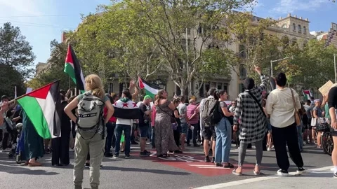 Protest by Palestinian activists in Barcelona. October 14, 2023. People walk Stock Footage 253785448