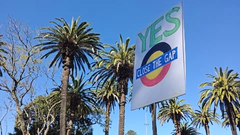 PROTEST PLACARD SAYS CLOSE THE GAP IN SUPPORT OF REFERENDUM YES VOTE NSW 4K Stock Footage 250442879