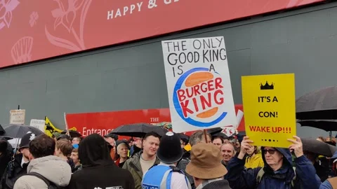 PROTEST PLACARD SAYS THE ONLY GOOD KING IS BURGER KING CORONATION 6 MAY 2023 4K Stock Footage 240493518