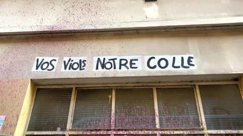 Protest poster stuck on a wall saying "your rapes our glue" in Paris, France Stock Footage 249677585