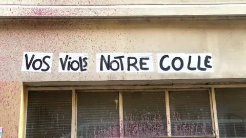 Protest poster stuck on a wall saying "your rapes our glue" in Paris, France Stock Footage 249677595