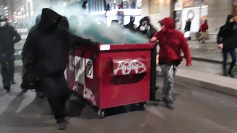 Protest running with container on fire during riot Stock Footage 105351602