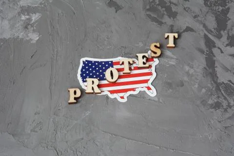 Protest sign flat lay on a gray background with american flag. Stock Photos