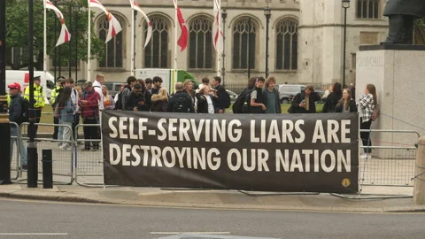 Protest sign at rally: Self serving liars are destroying our nation. England. Stock Footage 201597233