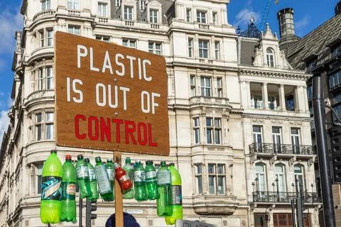 A protest sign with the text plastic is out of control decorated with plastic Stock Photos