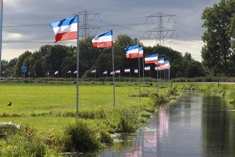 Protest signs and rows of flags upside down in Lekkerkerk along the N210 in.. Stock Photos