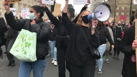 Protest for women’s rights marches through London Stock Footage 154685181