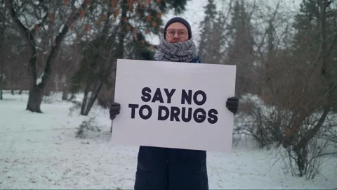 Protester demonstrating with banner Say no to Drugs to stop the substance abuse Video stock 201054600