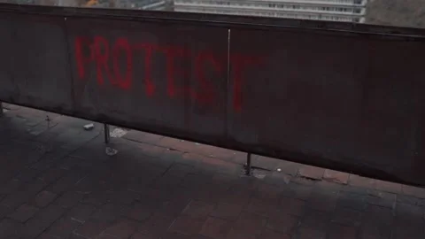 Protester goes out after making protest graffiti with red spray paint Stock Footage 143793594
