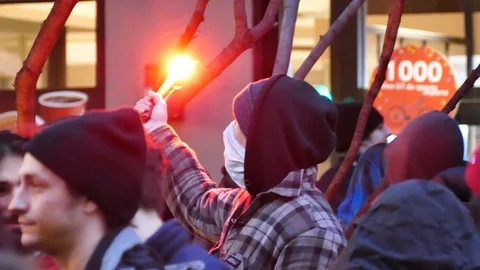 Protester holding red flair Stock Footage 105346294