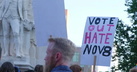 Protester holding up vote out hate home made sign Stock-Footage 198951917