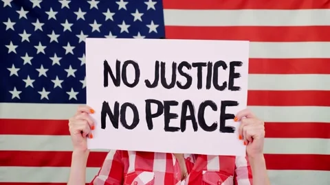 Protester holds a banner with a slogan - NO JUSTICE NO PEACE - against Stock Footage 132003406