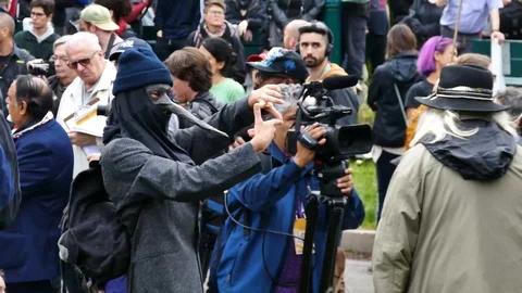 Protester making fun of a cameraman Stock Footage 92441182