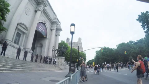 Protester POV: BLM Protesters march past Police Guarding Natural History Museum Stock Footage 133379393