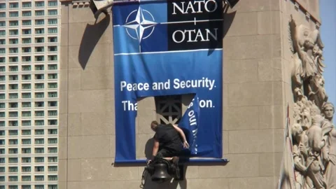 Protester Rips NATO Sign Stock Footage 149277348