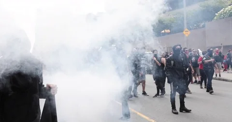 A protester  throws a smoke bomb during an anti-racism protest Stock Footage 79371586