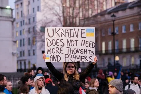 Protester with ‘Ukraine Does Not Need More Thoughts and Prayers’ Placard, UK Stock Photos