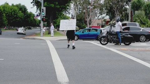 Protester walking through intersection Stock Footage 131788714