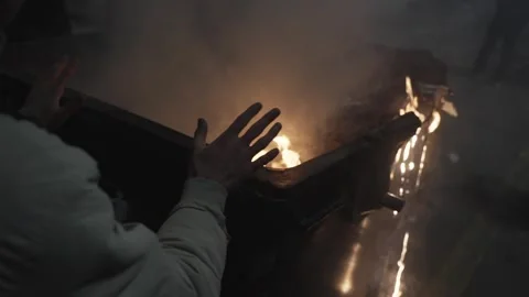 A protester warms his hands on a burning trash can Video stock 298007021