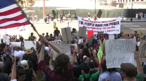 Protester waves a flag at City Hall - Occupy Los Angeles Stock-Footage 8765095