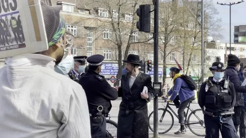 PROTESTER WTH 'THUGS' PLACARD AT KILL THE BILL PROTEST EASTER WEEKEND 2021 UK 4K Stock Footage 151542868