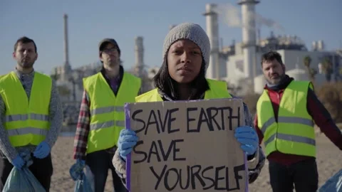Protester young latin activist looking at camera showing a banner Stock Footage 230180896