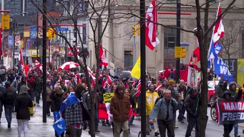 Protesters against COVID-19 Mandates March In Downtown Toronto Stock Footage 178486873