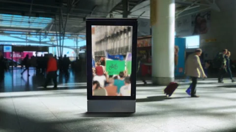 Protesters On Airport Digital Panel Passengers Passing Behind Stock Footage 170714071