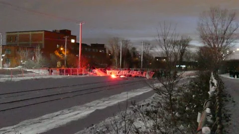 Protesters blocking train tracks with red flare Stock Footage 139658944