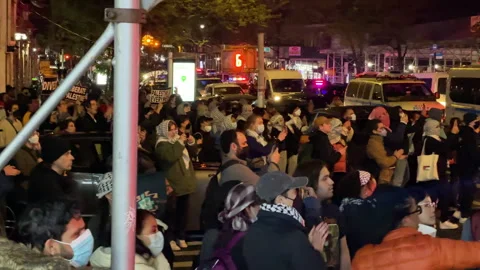 Protesters cheer for arrested crowd members on NYPD Police Bus - NY,NY - 4.30.24 Stock Footage 274600817