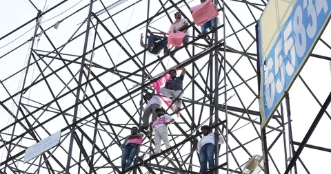 Protesters climb hoarding in India Stock Footage 98276636