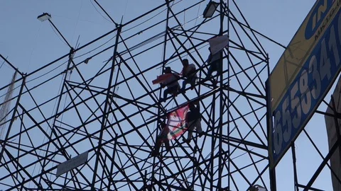 Protesters climb hoarding india Stock Footage 98434549