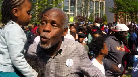 Protesters commemorate the Baltimore riots one-year later. Stock Footage 62533658