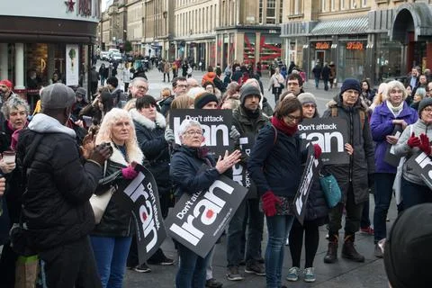 Protesters with Don't Attack Iran placard signs at a public demonstration Stock Photos