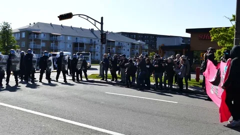Protesters facing anti-riot cops during the day Stock Footage 95266463