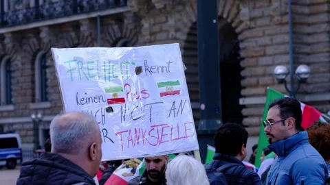 Protesters gather with signs and flags against the war in the middle east and Stock Footage 332613006
