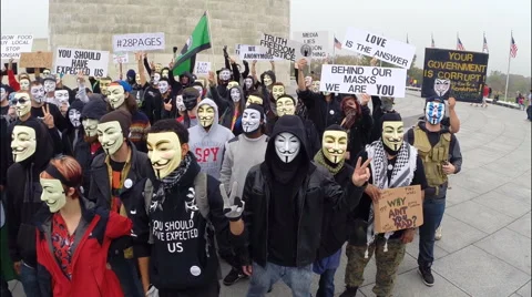 Protesters from the group Anonymous pose for a photo before marching. Video stock 56703705