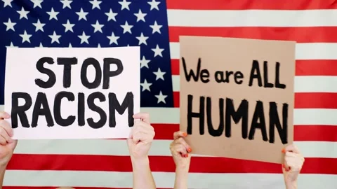 Protesters hold banners with slogans - Stop Racism. We are ALL HUMAN - against Stock Footage 132002015