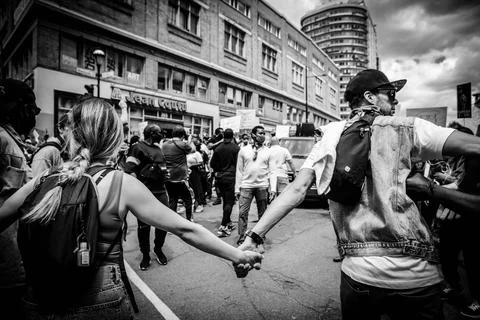 Protesters holding hands during protest Stock Photos