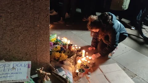 PROTESTERS LIGHT CANDLES AND LAY FLOWERS AT SARAH EVERARD DEMONSTRATION UK 4K Stock Footage 150400636