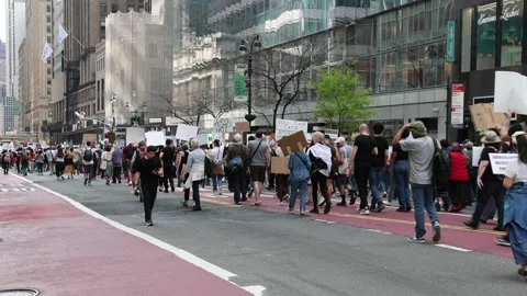 Protesters march down 42nd street midtown Manhattan protesting Donald Trump. Stock Footage 307135878
