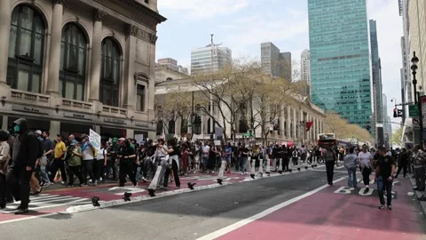 Protesters march down 42nd street midtown Manhattan protesting Donald Trump. Stock Footage 307135912