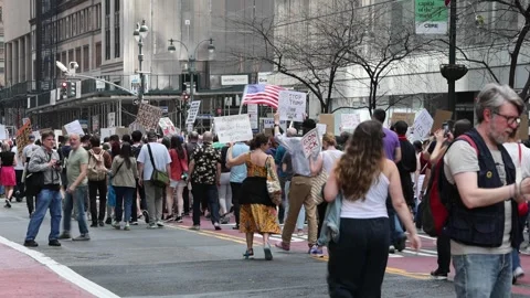 Protesters march down 42nd street midtown Manhattan protesting Donald Trump. Stock Footage 307135929