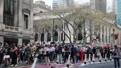 Protesters march down 42nd street midtown Manhattan protesting Donald Trump. Stock Footage 307135944