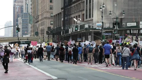 Protesters march down 42nd street midtown Manhattan protesting Donald Trump. Stock Footage 307135967