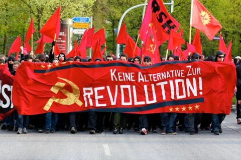 Protesters March with Red Banners Stock Photos